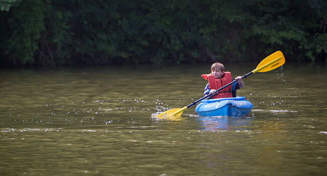 child on canoe